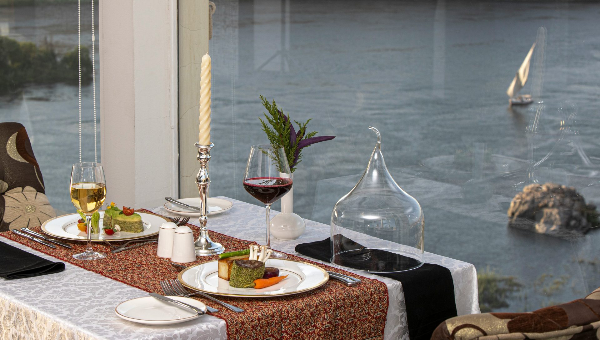 a table with plates and glasses of wine on it
